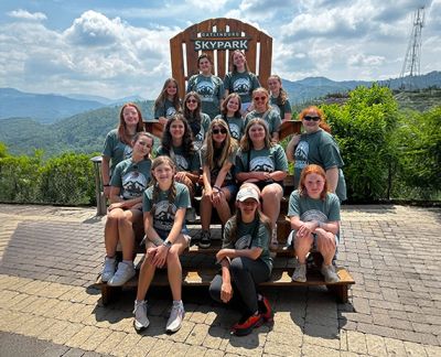 The touring group posed on an oversized chair at the Gatlinburg SkyPark overlook
