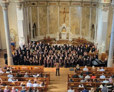 Overhead view of the full choir performing to a packed sanctuary