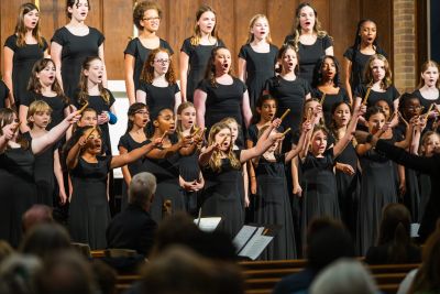 Singers reaching out together during a staged number