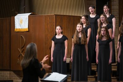 A small ensemble of older singers performing with their director