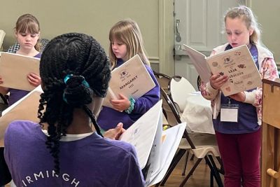 A singer auditioning with a Birmingham Girls Choir director