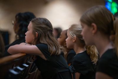 Young singers listening from the pews during the concert