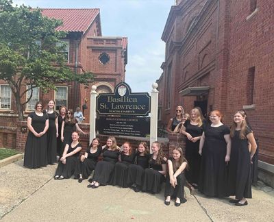 The choir in concert black outside the Basilica of St. Lawrence in Asheville