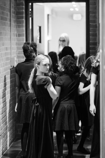 Singers waiting together in a hallway before taking the stage
