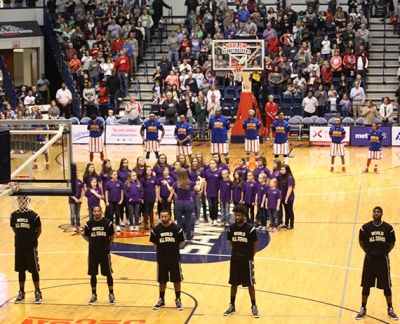 The choir performing on the court at a Harlem Globetrotters game