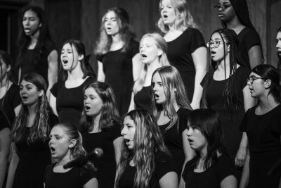 Black-and-white view of the older choir mid-phrase